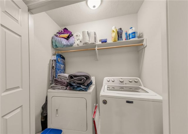 laundry area featuring independent washer and dryer and a textured ceiling