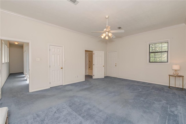 unfurnished room with dark colored carpet, ceiling fan, and crown molding