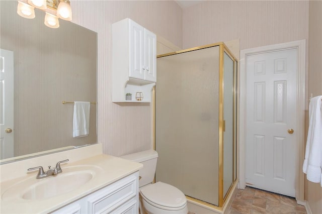 bathroom with vanity, toilet, and walk in shower