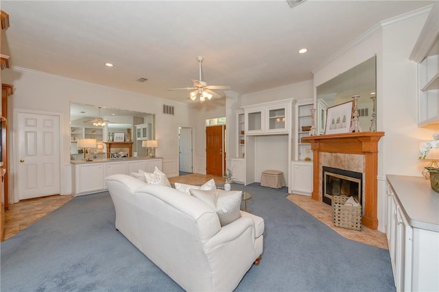 living room with light colored carpet, ornamental molding, and a fireplace