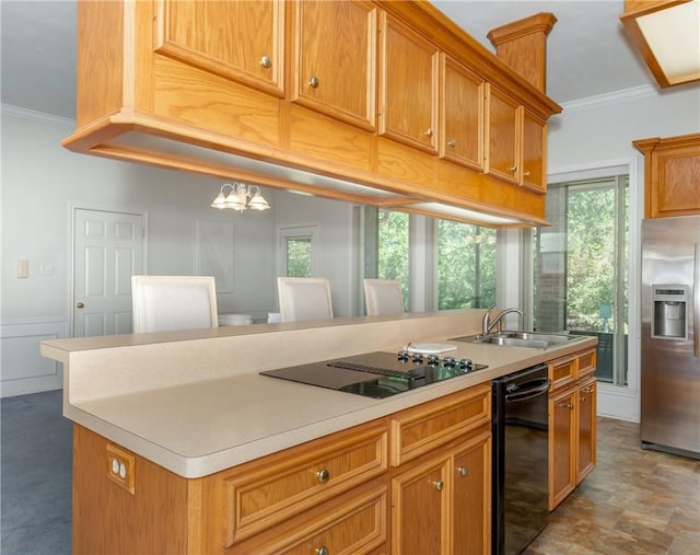 kitchen with a chandelier, a kitchen island, plenty of natural light, and black appliances