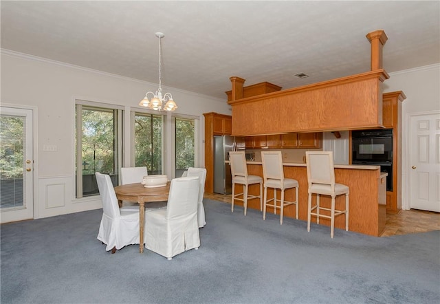 dining area with dark carpet, an inviting chandelier, and crown molding