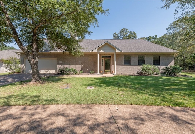 single story home featuring a front lawn and a garage