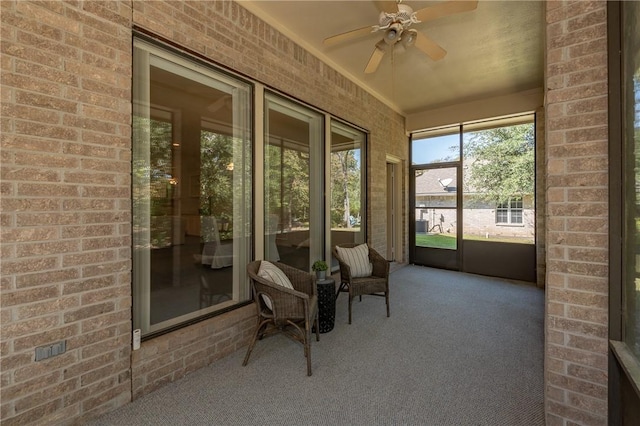 unfurnished sunroom featuring ceiling fan