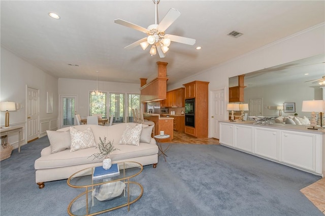 carpeted living room featuring ceiling fan and crown molding