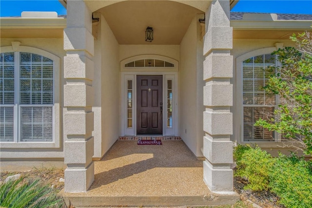 doorway to property with stucco siding