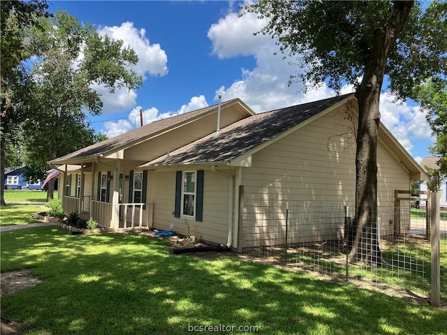 rear view of property with a lawn