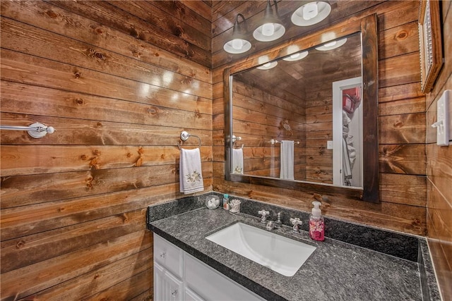 bathroom featuring wooden walls and vanity