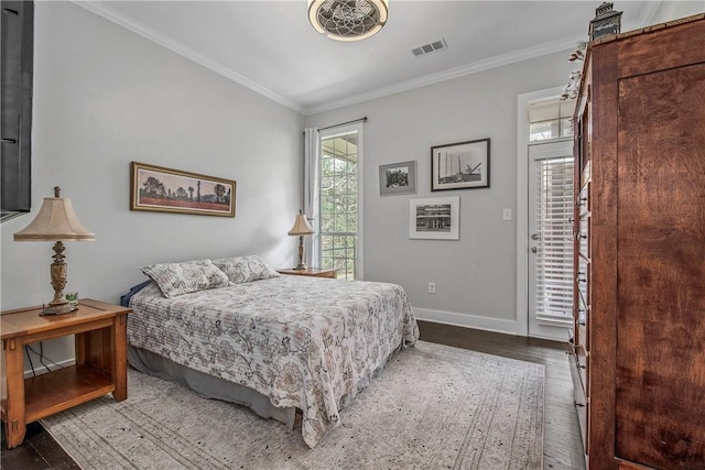 bedroom featuring visible vents, wood finished floors, crown molding, baseboards, and access to exterior