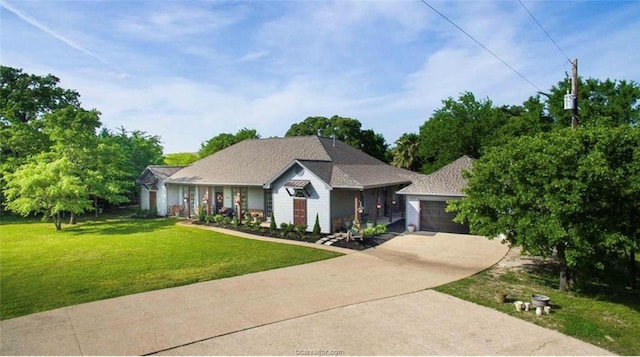 single story home with driveway, an attached garage, and a front yard