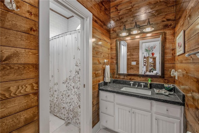 full bath with a shower with curtain, wooden walls, and vanity