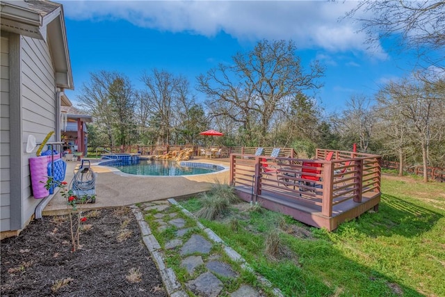 view of yard with a patio area, a fenced in pool, and a deck