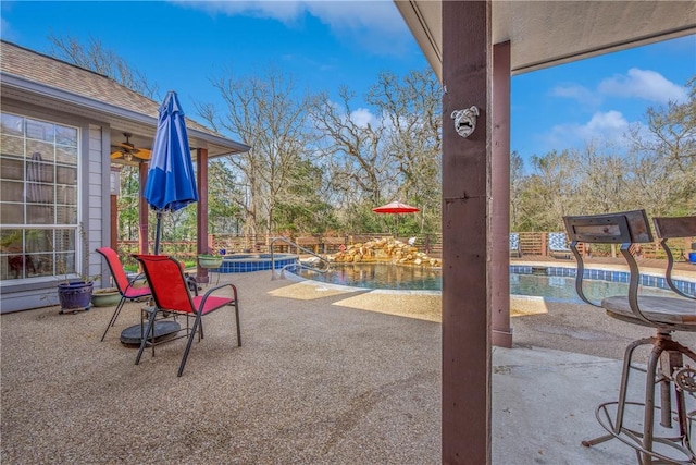 view of patio / terrace featuring a pool with connected hot tub