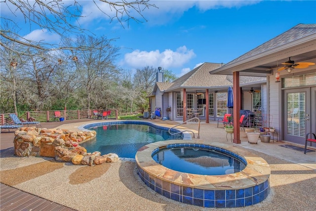 view of swimming pool with a fenced in pool, an in ground hot tub, french doors, and a patio