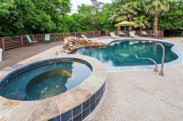 view of swimming pool with a fenced in pool, an in ground hot tub, and a deck