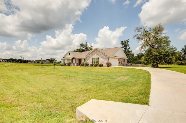 view of front of home with driveway, a garage, and a front yard