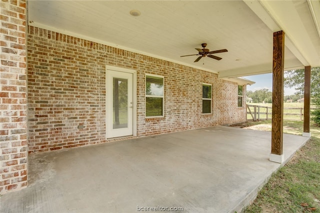 view of patio featuring fence and a ceiling fan