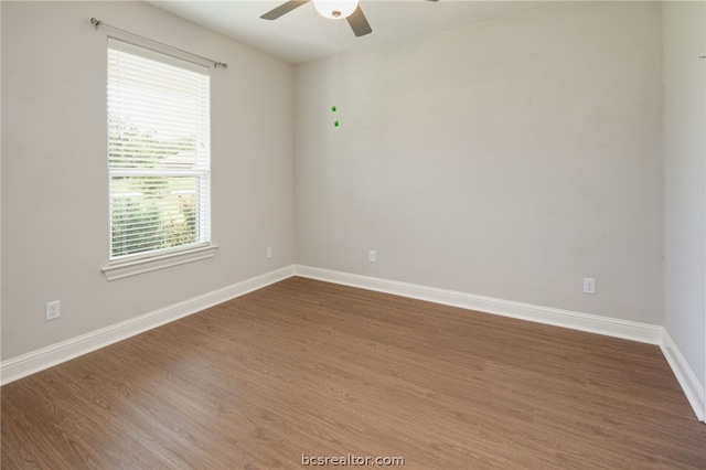 spare room featuring ceiling fan, baseboards, and wood finished floors