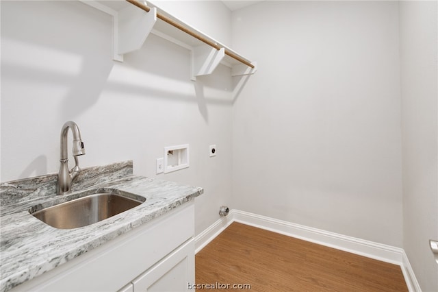 clothes washing area featuring hardwood / wood-style floors, electric dryer hookup, sink, and washer hookup