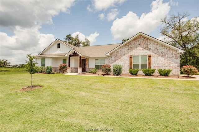 ranch-style home featuring a front lawn, board and batten siding, and brick siding