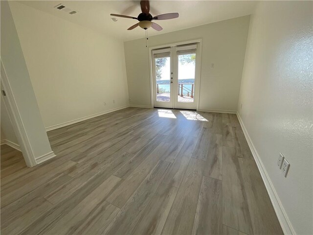 15933 Goliad Loop, Temple, TX 76502 - spare room featuring french doors, wood finished floors, baseboards, and ceiling fan