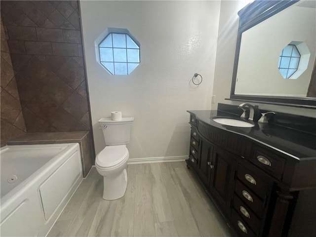 15933 Goliad Loop, Temple, TX 76502 - full bathroom featuring wood finished floors, vanity, toilet, baseboards, and shower / washtub combination