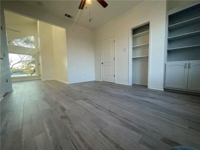 15933 Goliad Loop, Temple, TX 76502 - empty room featuring a ceiling fan, wood finished floors, baseboards, and built in features