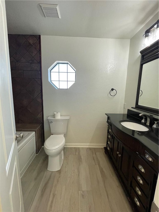 15933 Goliad Loop, Temple, TX 76502 - full bathroom with wood finished floors, vanity, toilet, shower / bath combination, and baseboards
