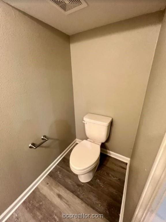 1305 W Villa Maria Rd Unit D107, Bryan, TX 77801 - bathroom featuring toilet, wood finished floors, and baseboards