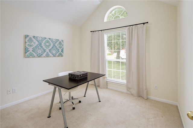 carpeted office space featuring baseboards and high vaulted ceiling