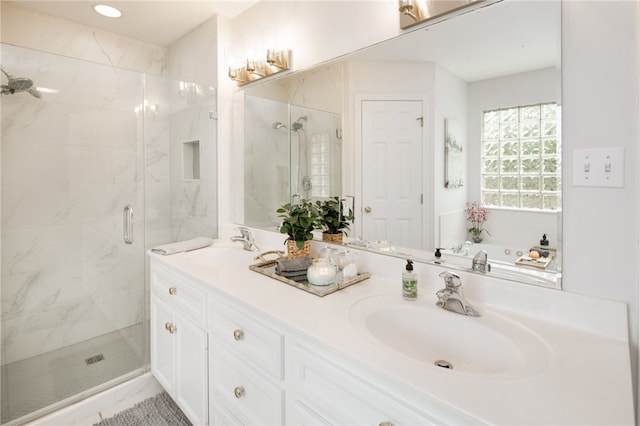 full bathroom featuring a sink, a shower stall, and double vanity