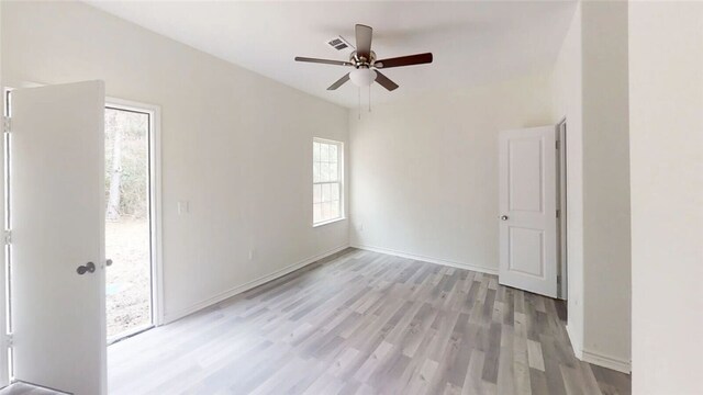 unfurnished room with ceiling fan and light wood-type flooring