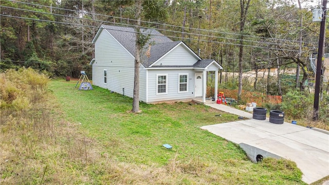 view of front of property with a patio area and a front yard