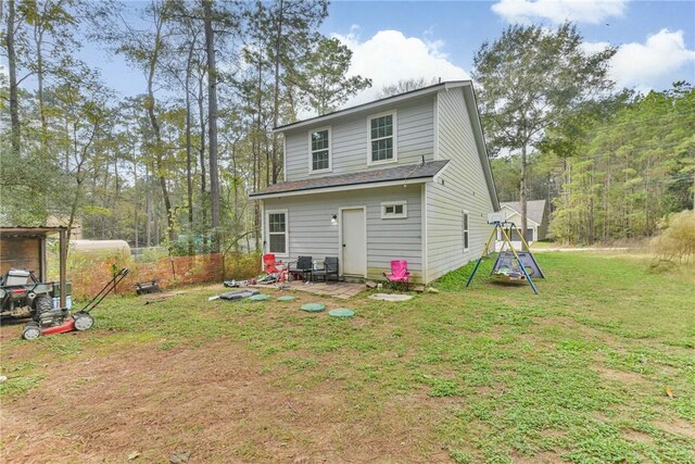 rear view of property with a yard