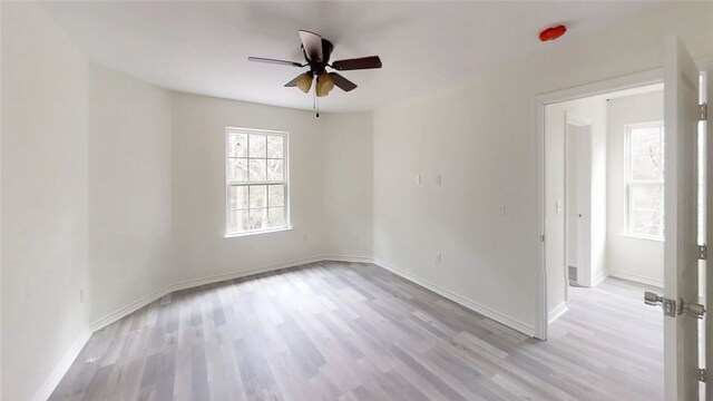 spare room with light wood-type flooring and ceiling fan