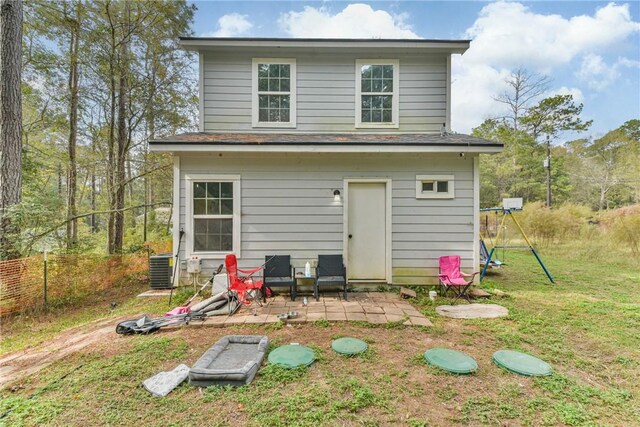 back of house featuring central AC, a yard, and a patio