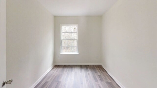 unfurnished room with light hardwood / wood-style flooring