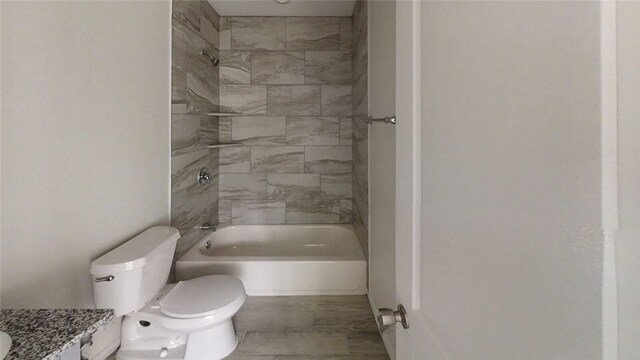 full bathroom featuring vanity, toilet, and tiled shower / bath