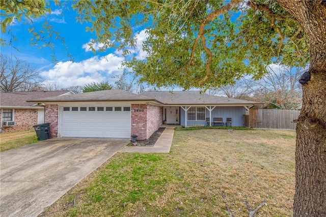 ranch-style home featuring a garage, cooling unit, and a front lawn