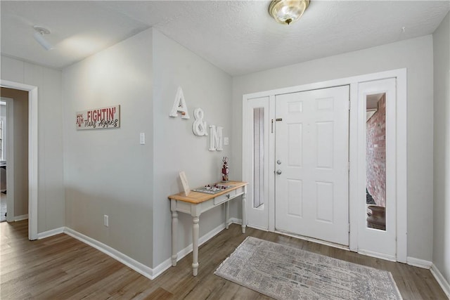 foyer featuring hardwood / wood-style flooring and a textured ceiling