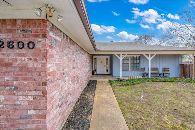 entrance to property with a yard