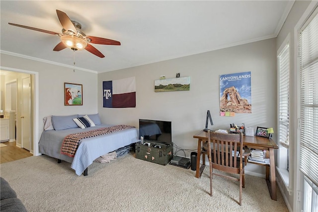 bedroom with ceiling fan, ornamental molding, and light carpet