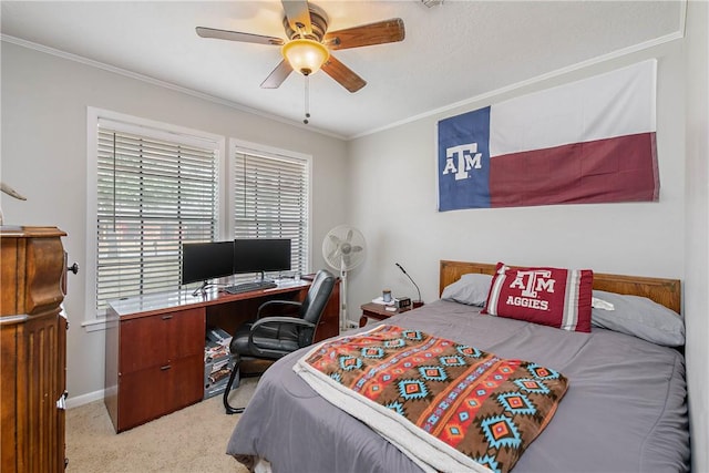 bedroom with ornamental molding, light colored carpet, and ceiling fan