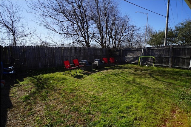 view of yard with a fenced backyard