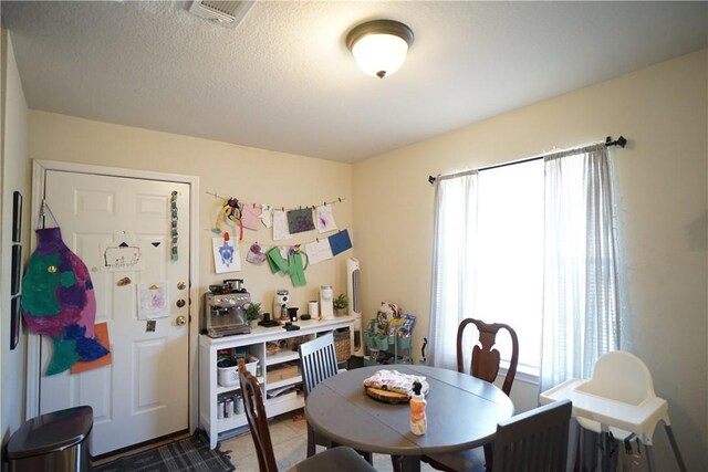 dining space with a textured ceiling