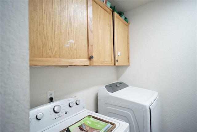 laundry area featuring cabinet space and separate washer and dryer