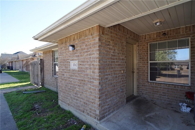 exterior space featuring brick siding