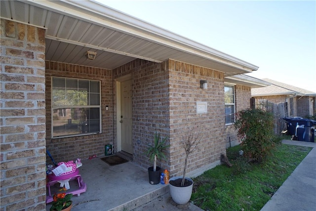 entrance to property with brick siding