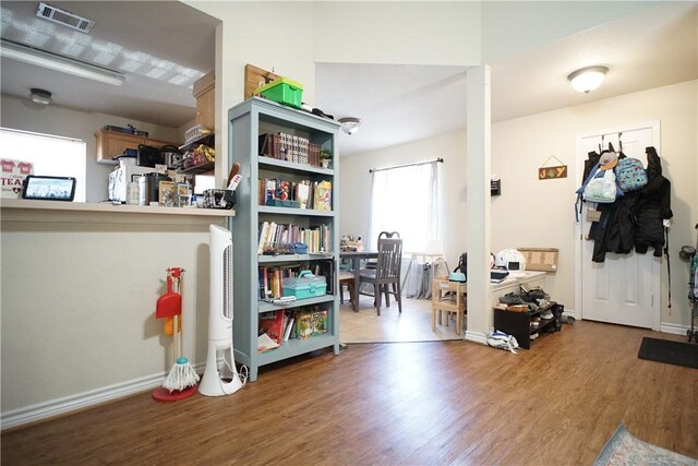 interior space featuring wood finished floors, visible vents, and baseboards