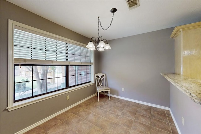 3900 Puffin Way, College Station, TX 77845 - unfurnished dining area with a chandelier, baseboards, and tile patterned flooring